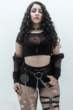 Andrea Garcia wearing a black mesh goth crop top featuring a red rose